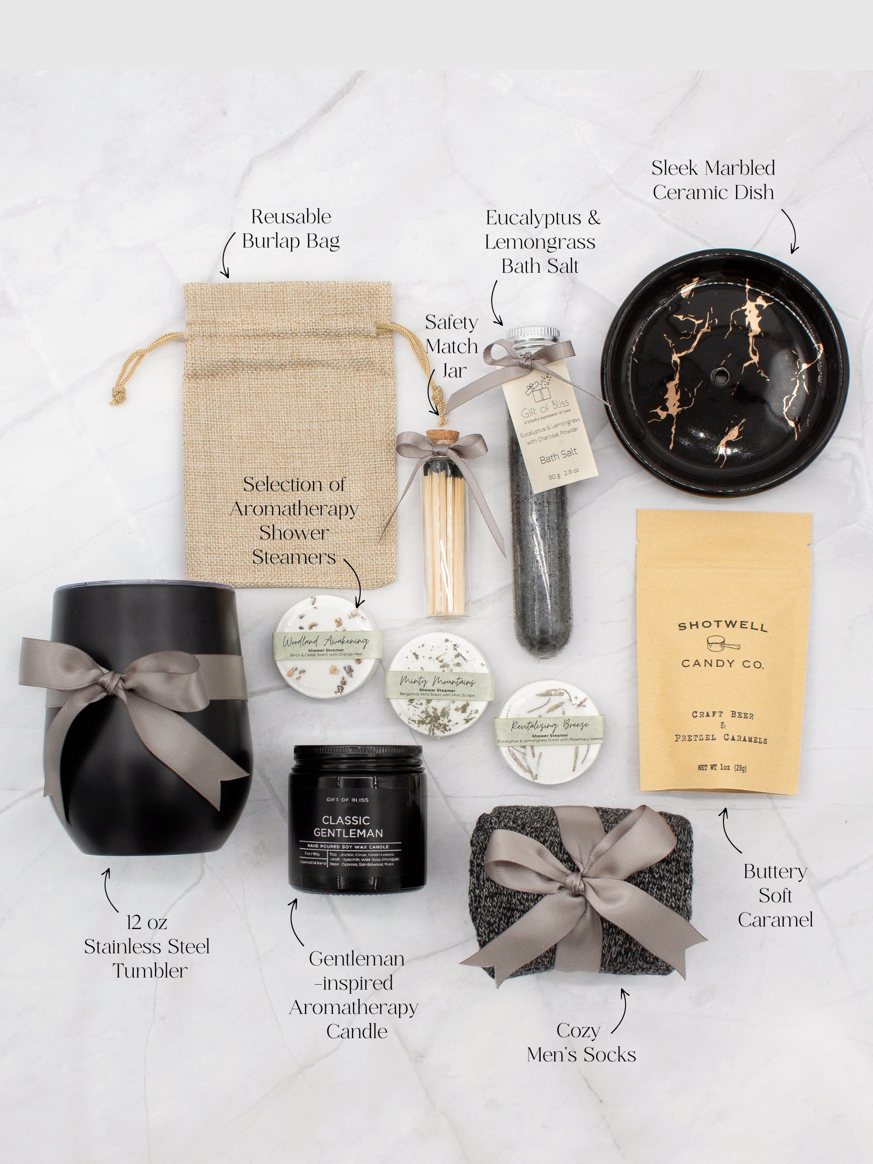 Specially crafted gift box that brings luxury and relaxation. Includes a 12oz stainless steel tumbler, sweet treats, an aromatic candle and matches, cozy socks, bath salt, shower steamers, and an elegant ceramic dish for a serene experience.