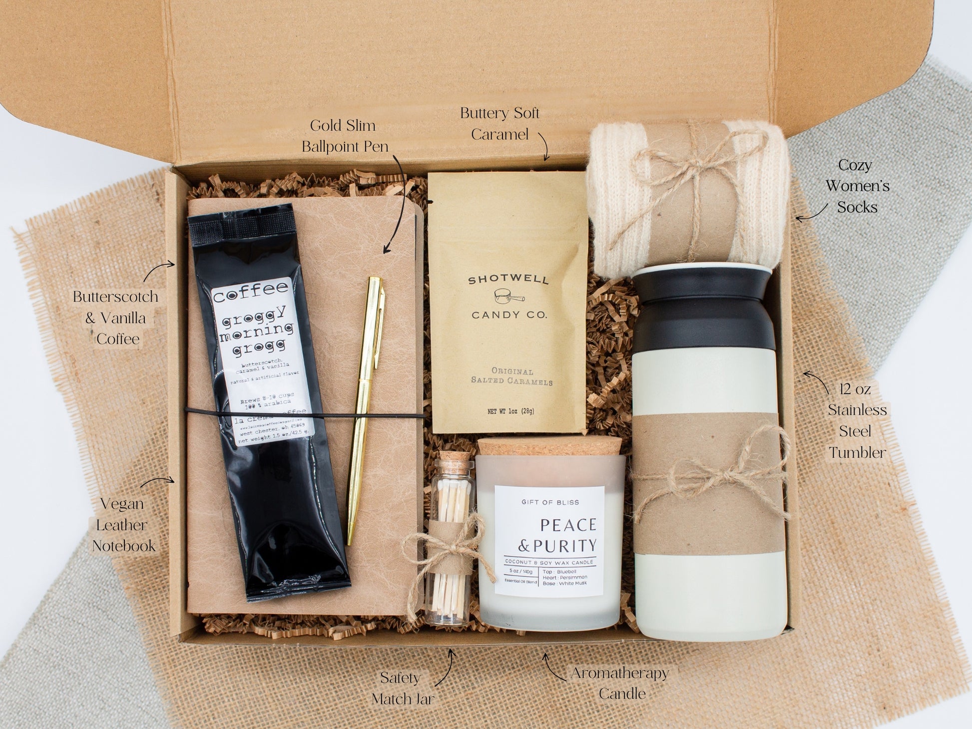 A specially crafted gift box for those who appreciate rustic charm and elegance. Features 12 oz tumbler, coffee, luxurious caramel, notebook with gold pen, soothing candle with matches, and cozy socks, perfect for both relaxation and practicality.