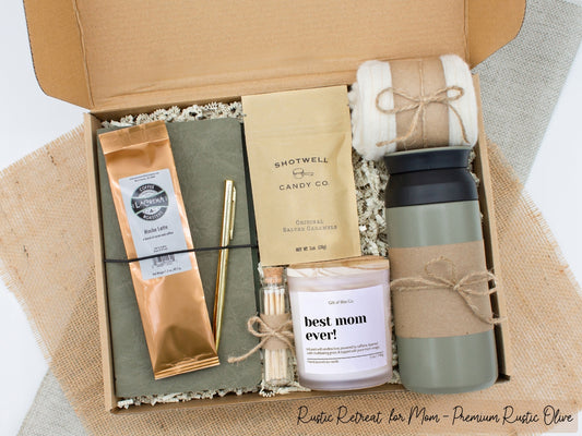 A specially crafted gift box for moms who appreciate rustic charm and elegance. Features 12 oz tumbler, coffee, luxurious caramel, notebook with gold pen, soothing candle with matches, and cozy socks, perfect for both relaxation and practicality.
