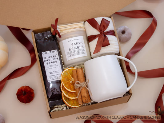 A comforting kraft box with a taupe ceramic mug, Earth & Ember candle, butterscotch vanilla coffee, soft socks, cinnamon sticks, and dried orange slices—everything needed to savor a peaceful coffee break.