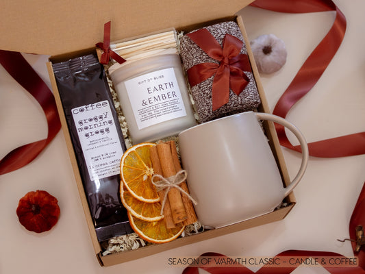 A comforting kraft box with a taupe ceramic mug, Earth & Ember candle, butterscotch vanilla coffee, soft socks, cinnamon sticks, and dried orange slices—everything needed to savor a peaceful coffee break.