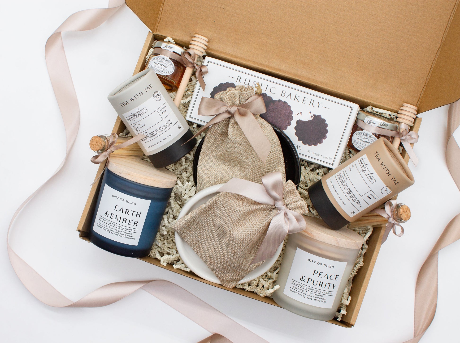 A spa gift box for 2. Features shortbread cookies, 2 soothing tea blends, honey and wooden dipper, 2 aromatic candles, and 2 sets of shower steamers. This elegantly curated box, ideal for couples, enhances shared moments of intimacy and relaxation.