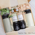 A gift box designed for two. Includes two stainless steel tumblers, a selection of fine tea and honey, elegant match jars, uniquely scented candles, and cozy socks for both. Ideal for creating shared moments of relaxation and connection.