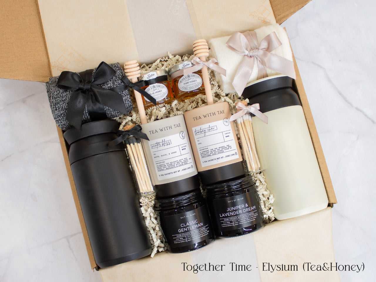 A gift box designed for two. Includes two stainless steel tumblers, a selection of fine tea and honey, elegant match jars, uniquely scented candles, and cozy socks for both. Ideal for creating shared moments of relaxation and connection.