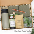 Specially crafted gift box for men, ideal for anyone. Includes a stainless steel tumbler, tea, honey, sweet treats, cozy socks, vegan leather notebook, & wooden pen. Perfect for relaxation & appreciation, complete with a personalized greeting card.