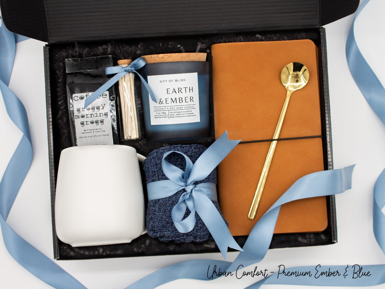Specially crafted gift box, ideal for modern individuals who value style and comfort. Includes 12 oz ceramic mug, long-handled golden spoon, rich coffee, aromatic candles and matches, stylish men's socks, and notebook, all arranged for a memorable experience.