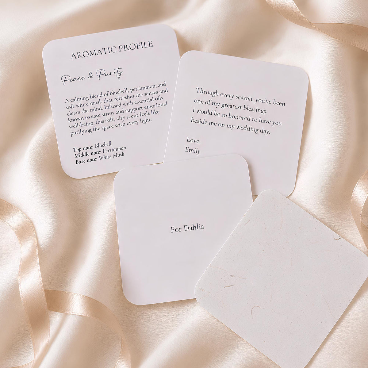 Personalized keepsake booklet cards showing the Peace and Purity scent profile and a message to the bridal party member