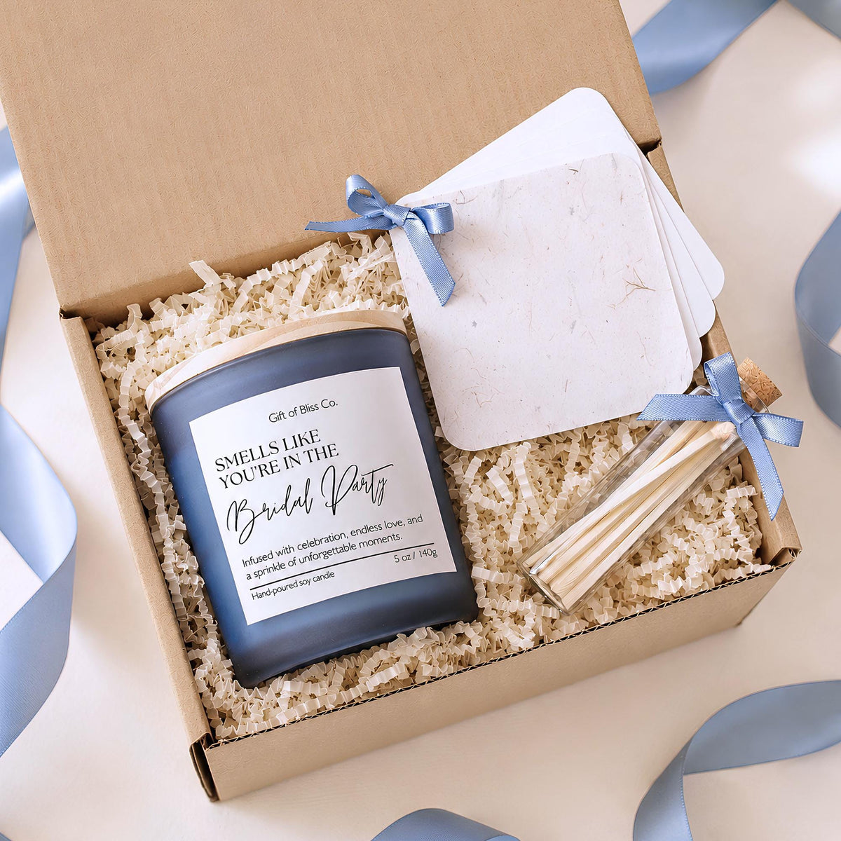 Smells Like You're in the Bridal Party candle in a blue frosted jar with safety matches and keepsake booklet in a kraft gift box